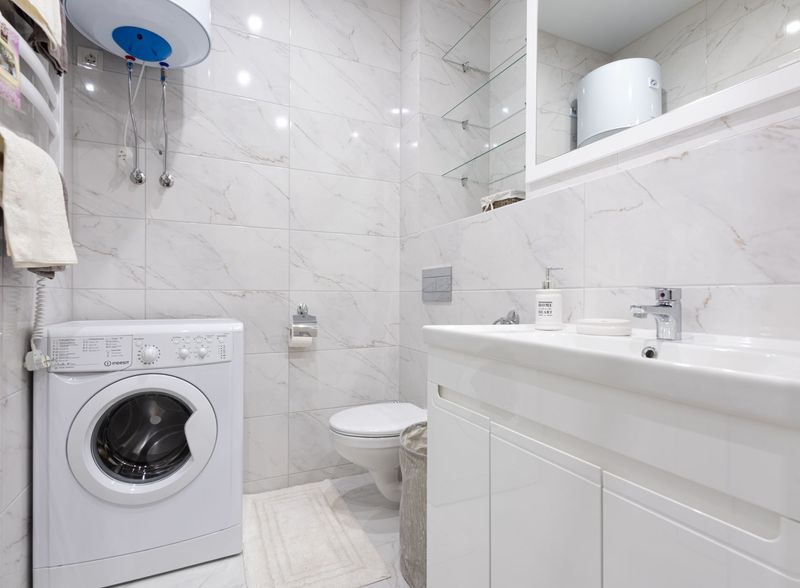 Calgary homeowner removing hair and debris from a bathroom drain strainer