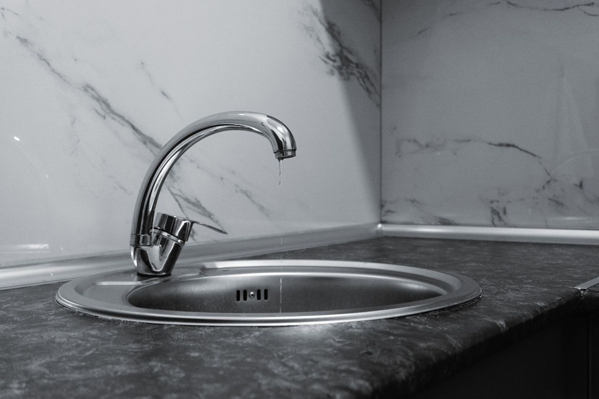 BPR Mechanical Ltd plumber repairing kitchen plumbing in an Inglewood home