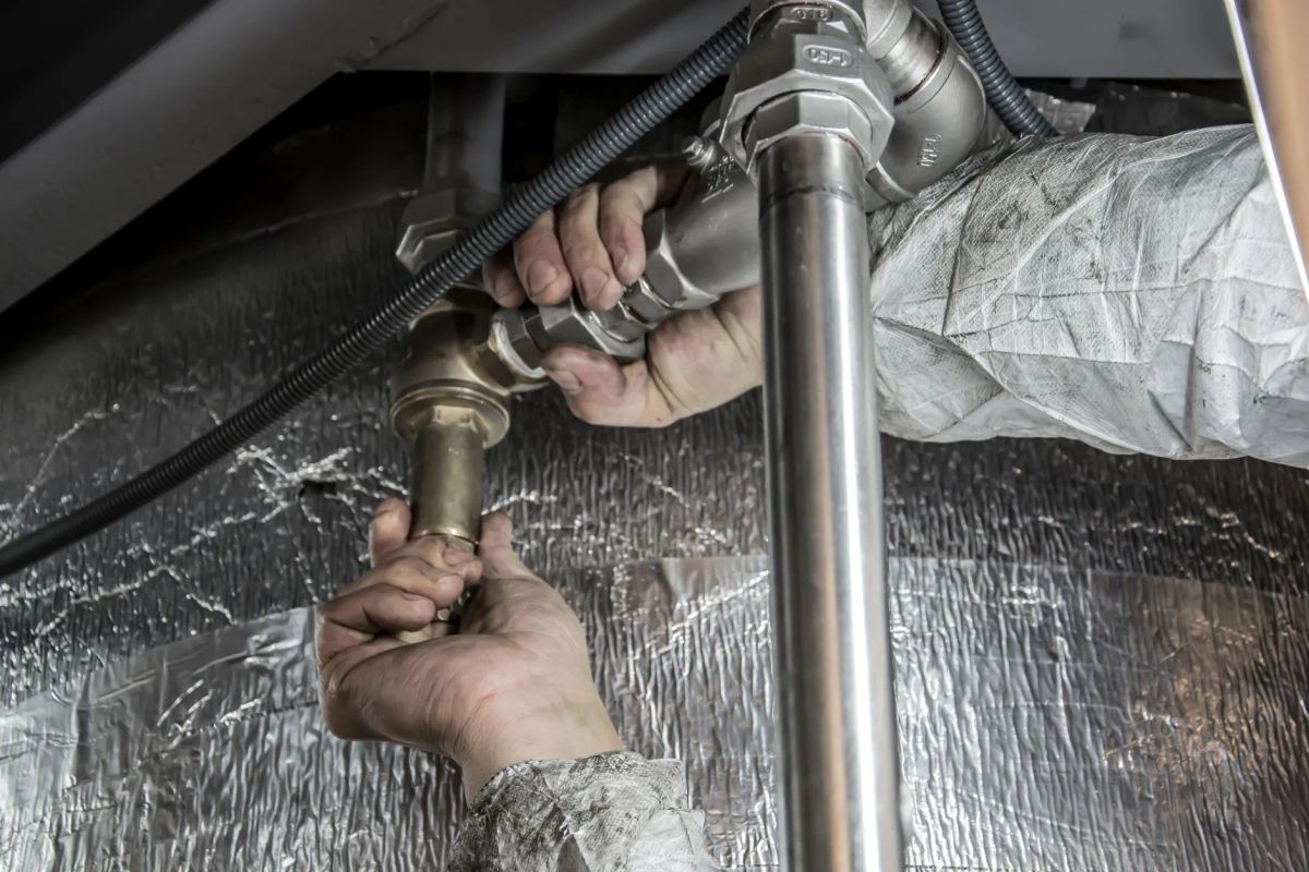 BPR Mechanical Ltd plumber inspecting bathroom pipes in a Ramsay residence
